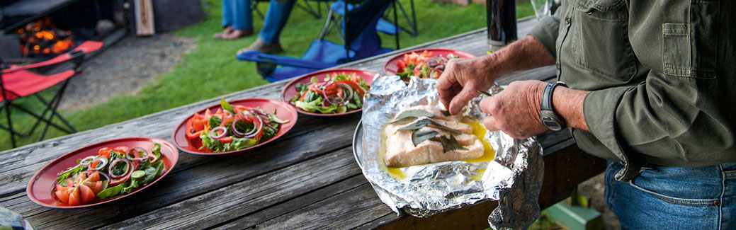 salad and salmon being plated