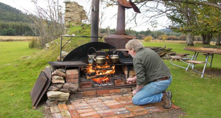 Guide stoking the campfire